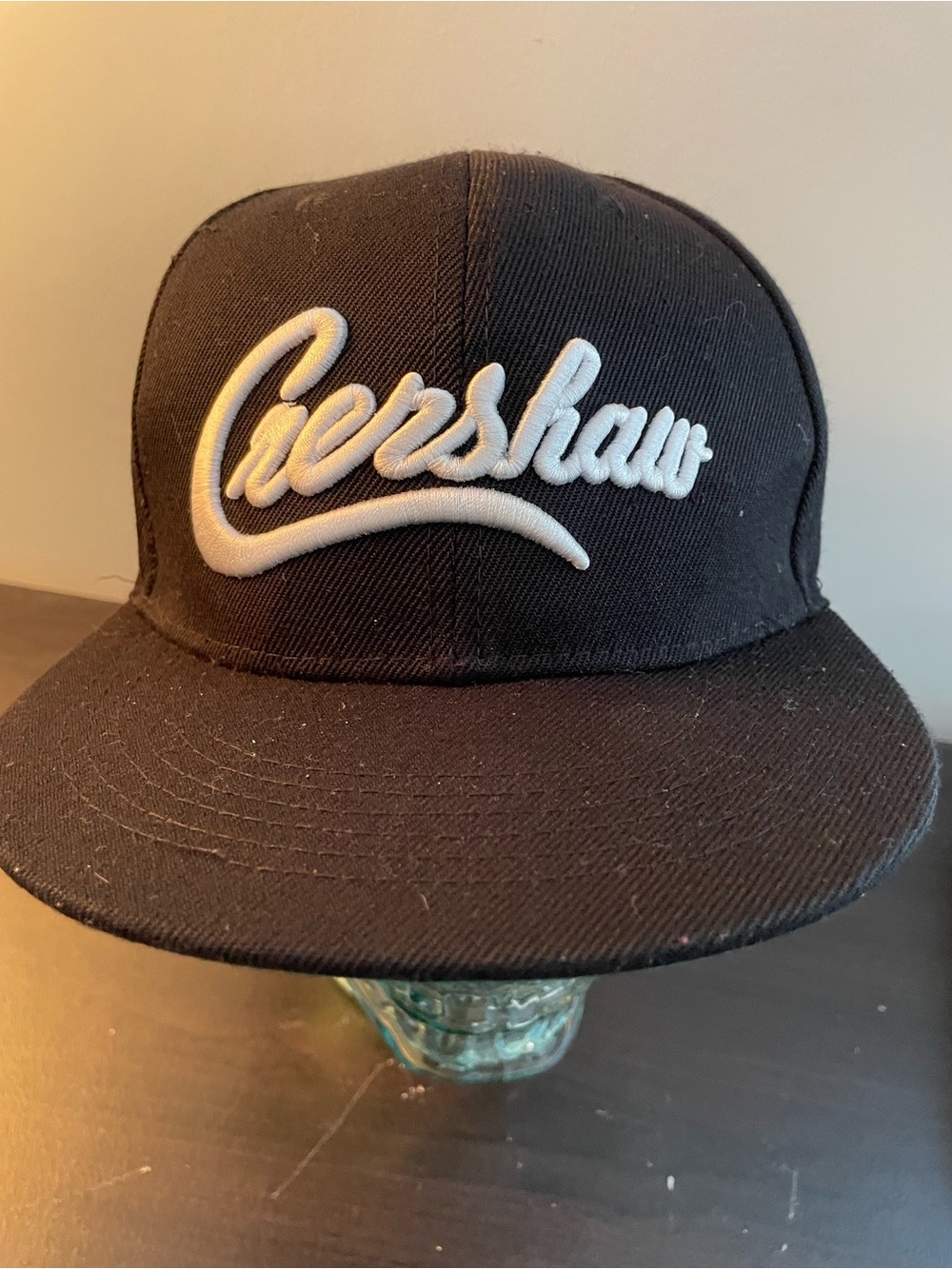 Black Snapback Hat with White Script Logo